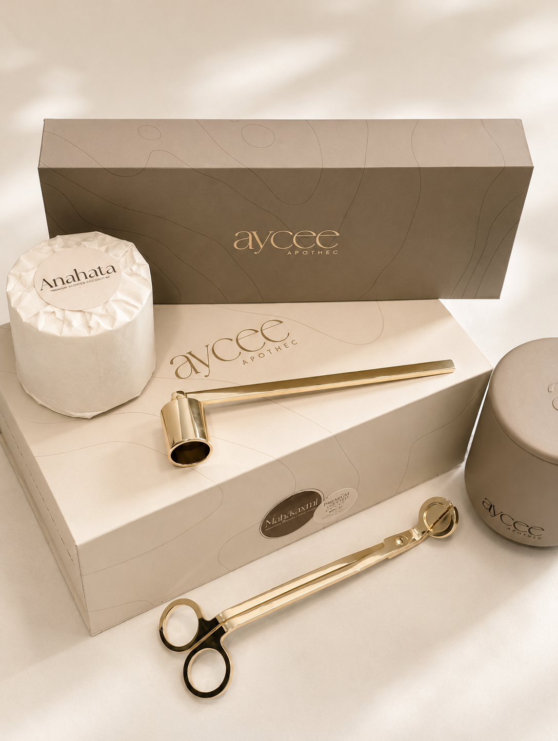 Aaycee Apothec products including a gold tool, snuffer, and a container on a white surface with a branded box.