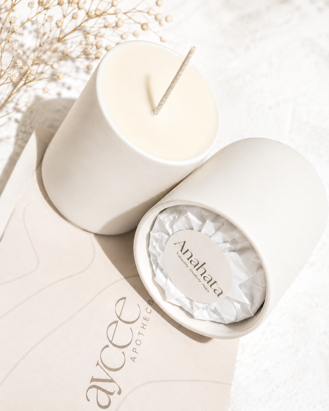 Candle jar with wrapped and unwrapped candle refill on an Aycee Apothec box